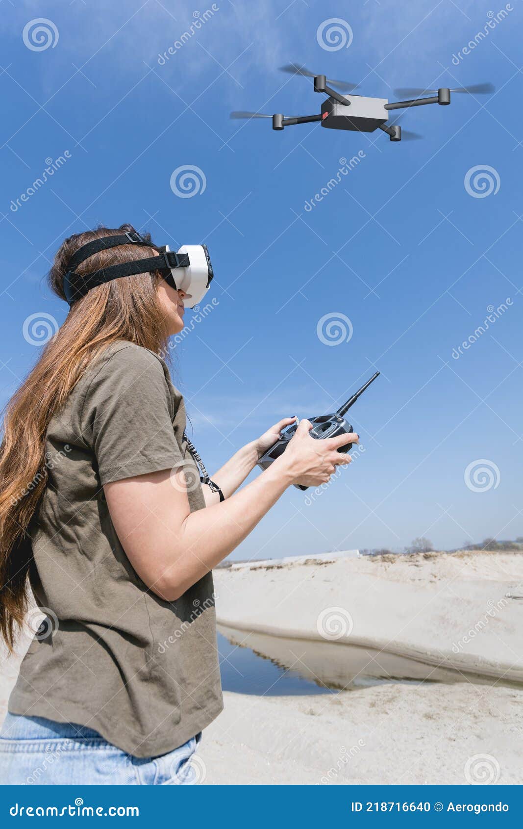 Woman Flying a Drone with Remote Controller and Virtual Reality Goggles