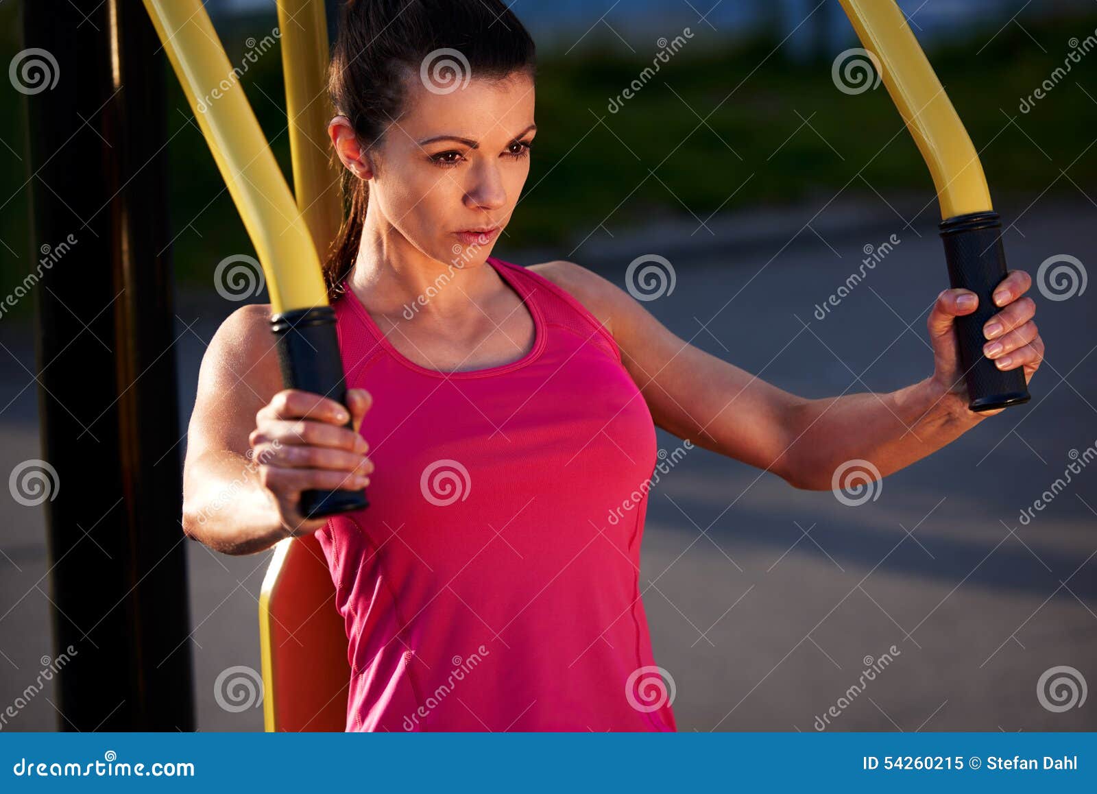 woman focussed while exercising upper body.