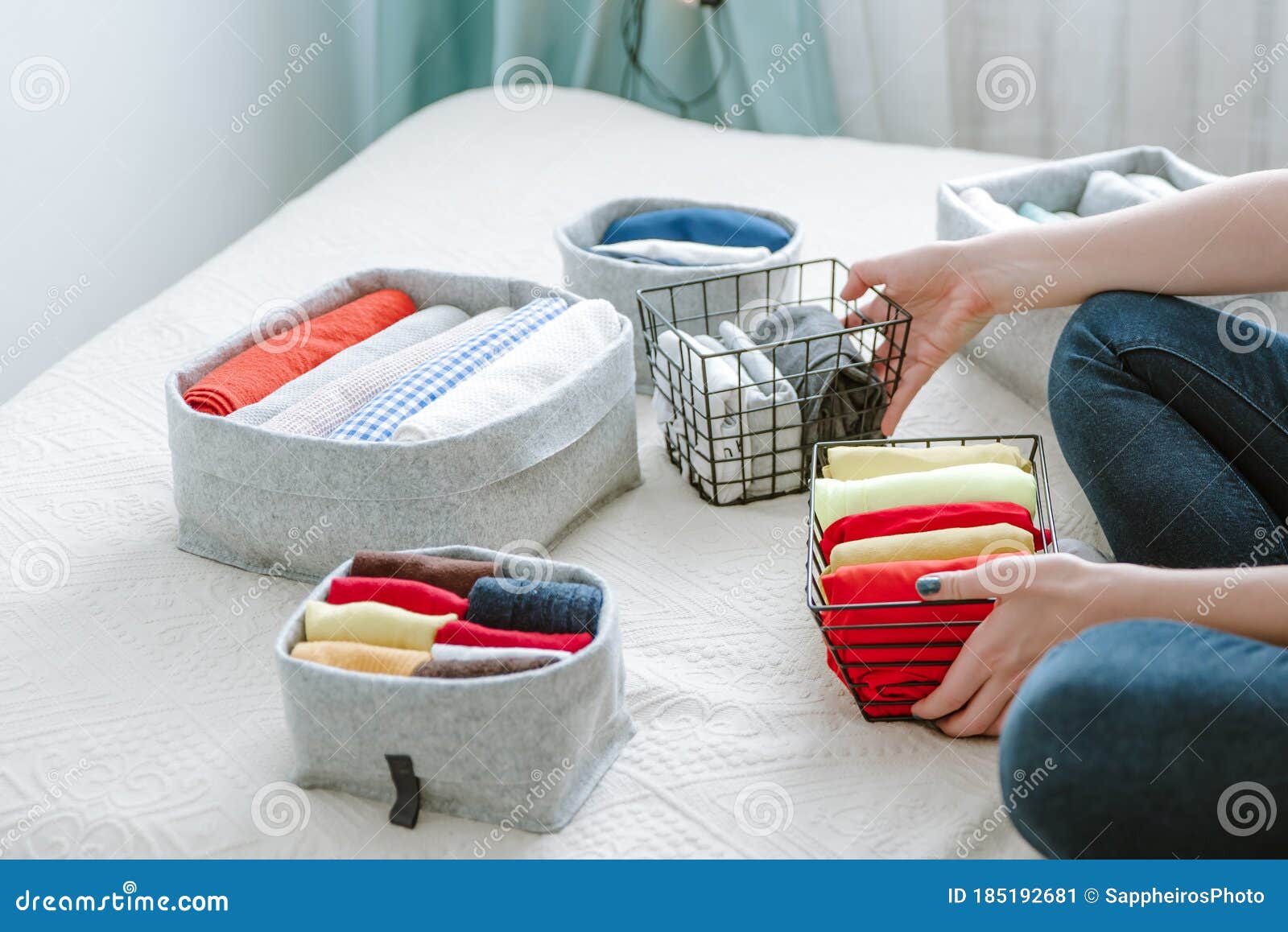 woman folding clothes, organizing stuff and laundry in boxes
