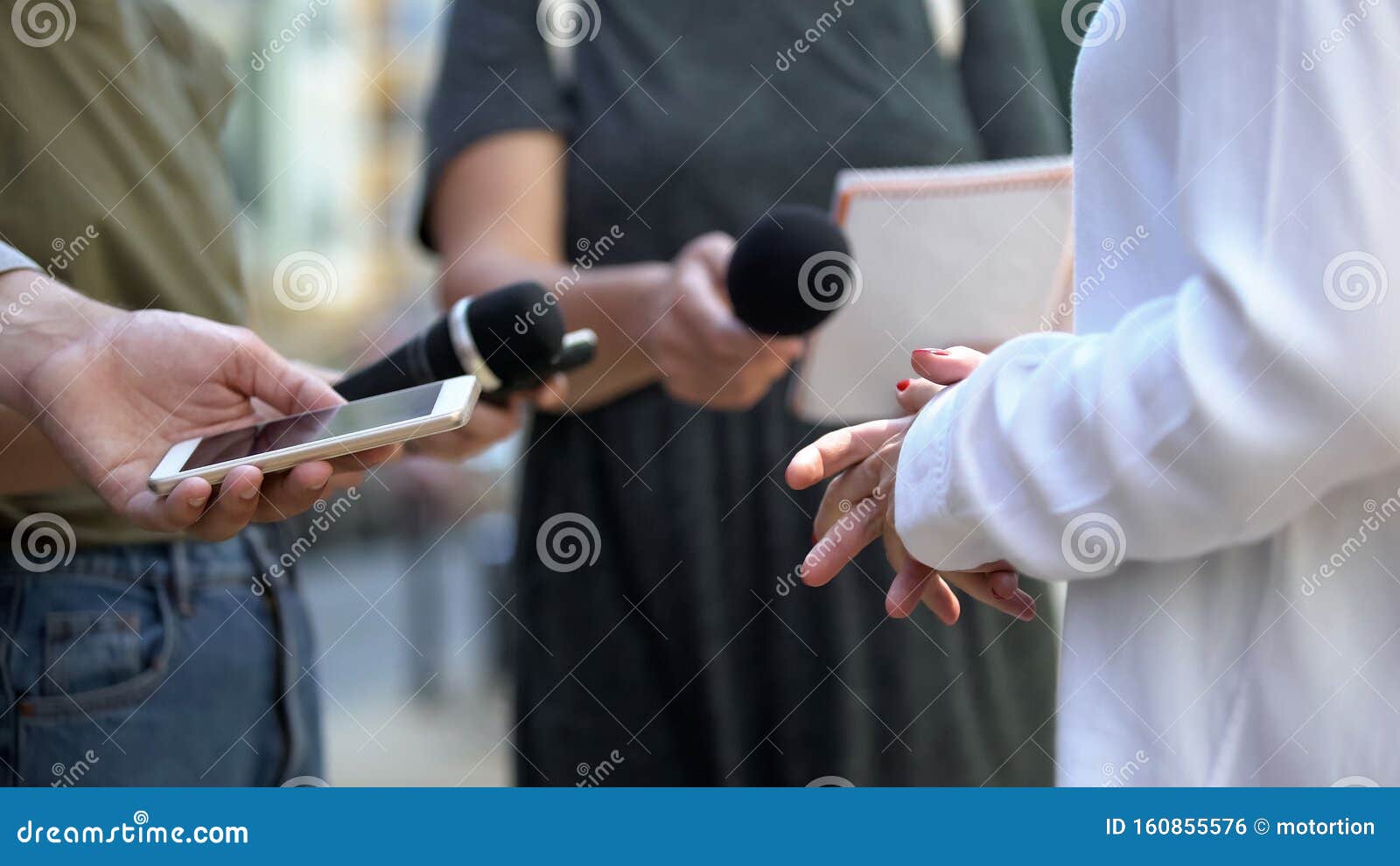 woman gesticulating during interview with media, press conference, close-up
