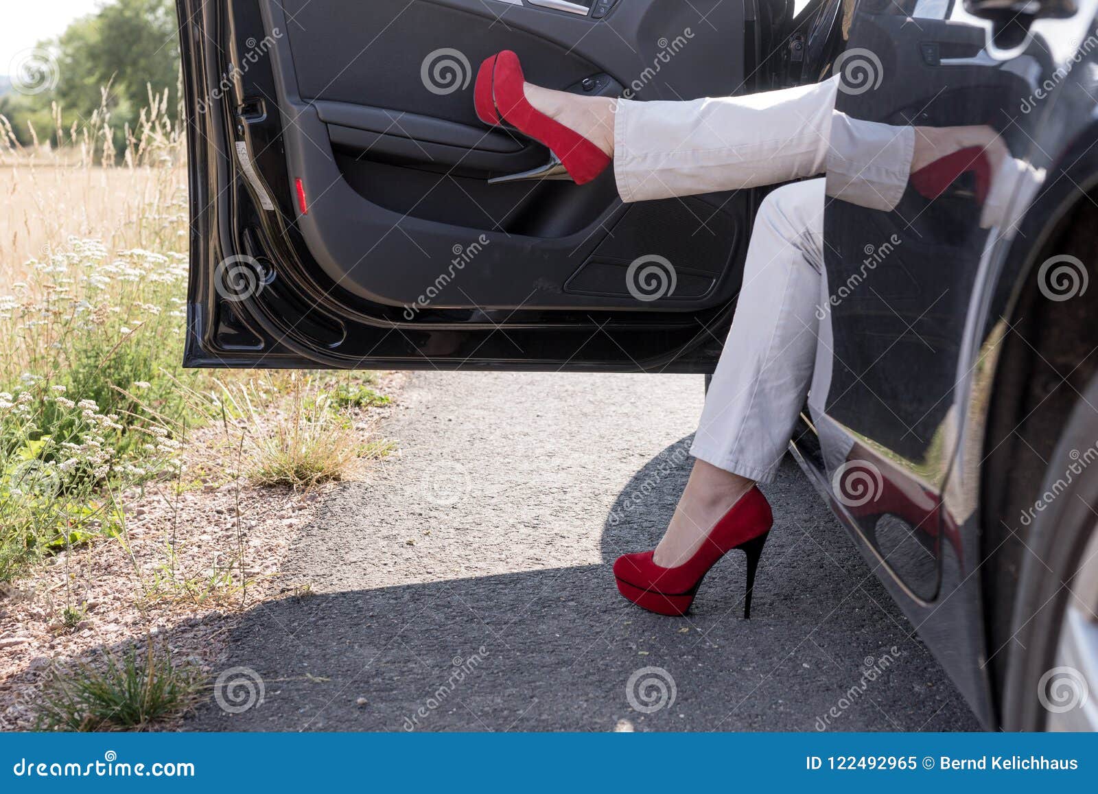 Woman Gets Out of the Car. Legs with Red High Heeled Shoes Stock Image ...