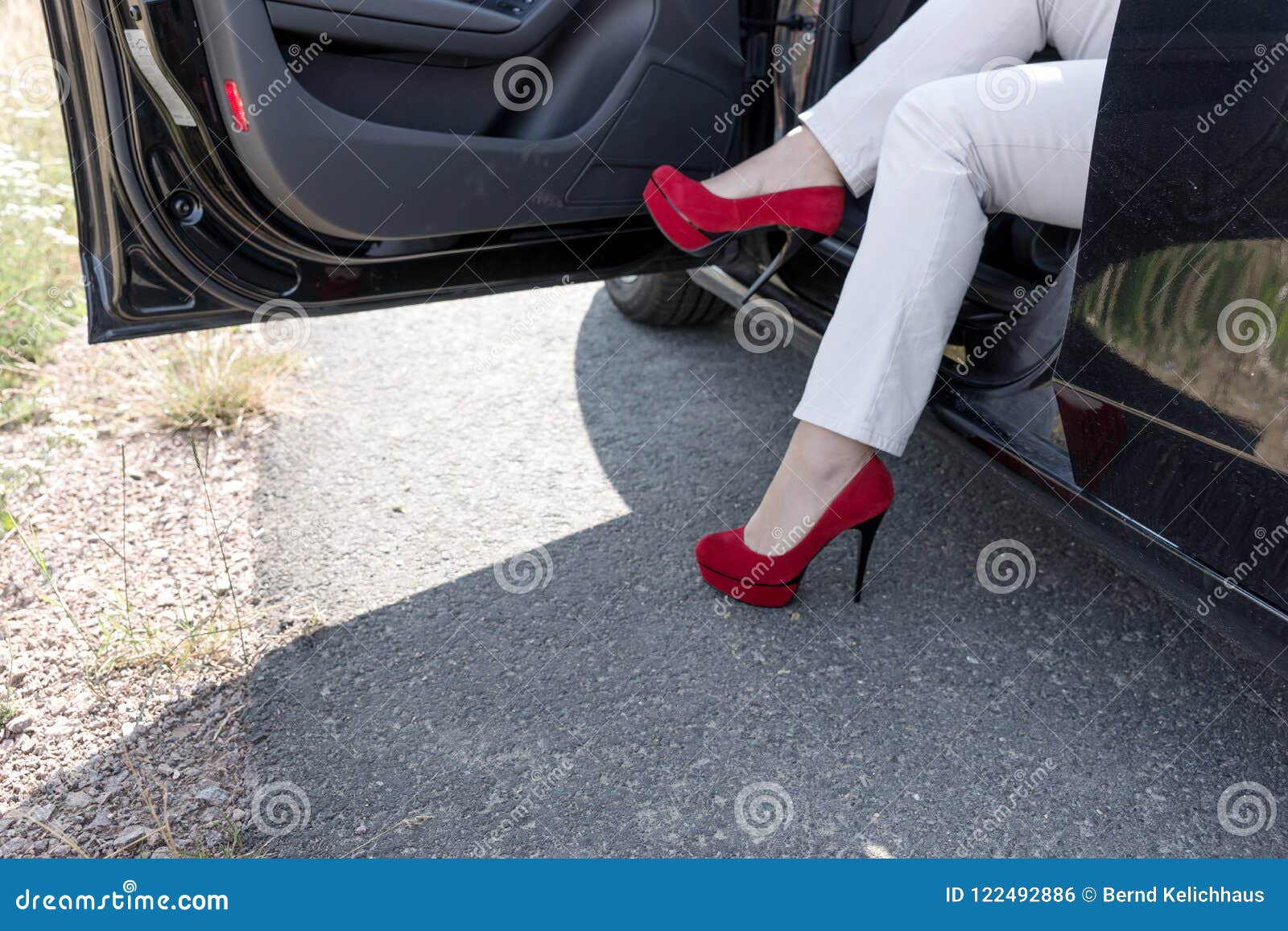 Woman Gets Out of the Car. Legs with Red High Heeled Shoes Stock Photo ...