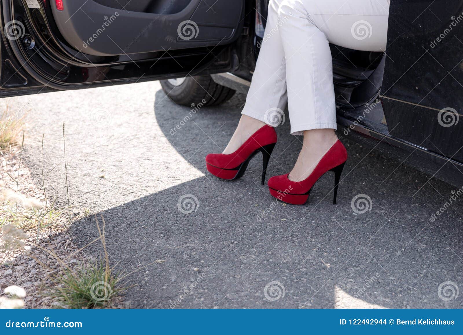 Woman Gets Out of the Car. Legs with Red High Heeled Shoes Stock Photo ...