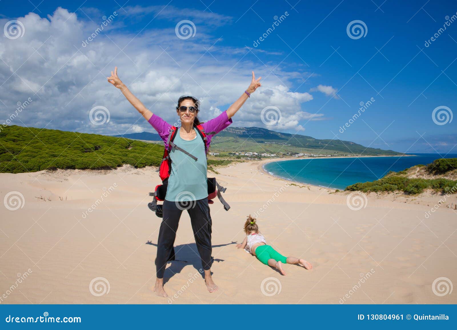 woman and girl on top of the dune of bolonia beach in cadiz