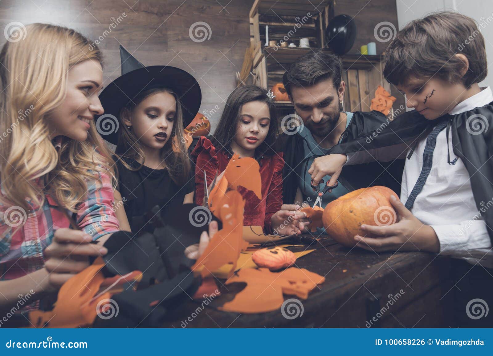 Happy Family Carves Decorative Bats from Paper for a Halloween Party ...