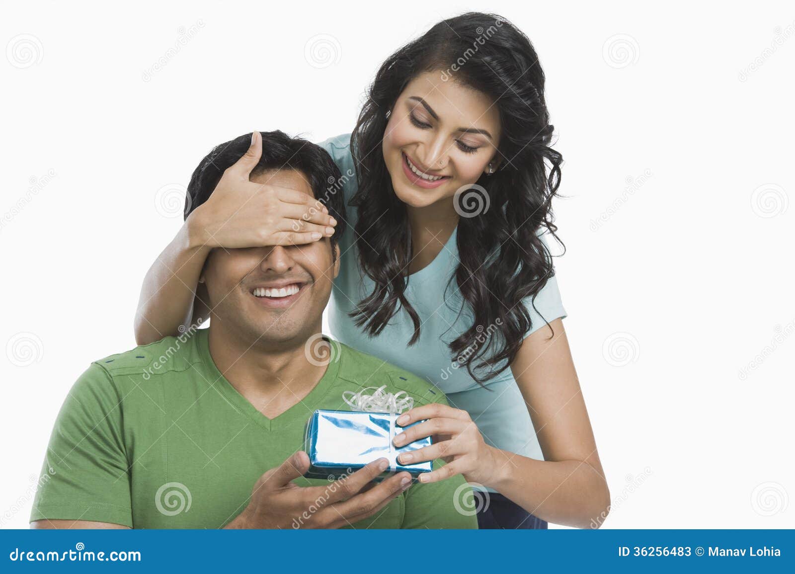 woman giving a gift to her husband