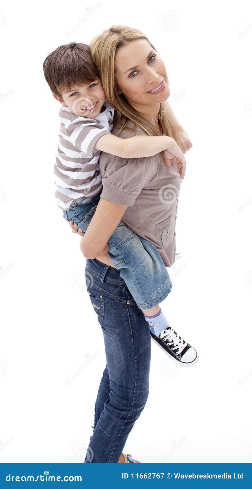Happy mother giving her son a piggyback ride in the city stock photo