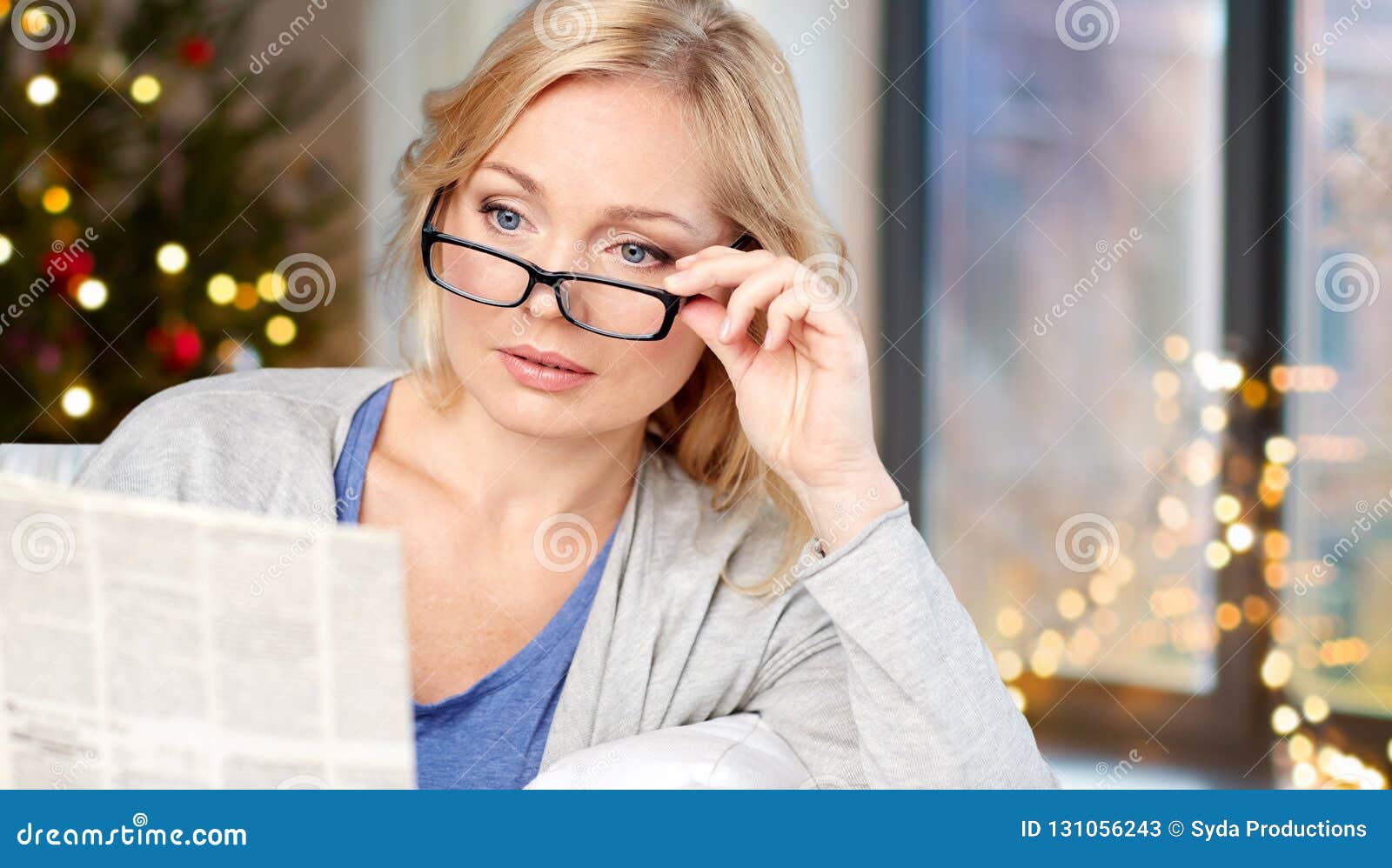 Woman In Glasses Reading Newspaper Over Christmas Stock Image Image