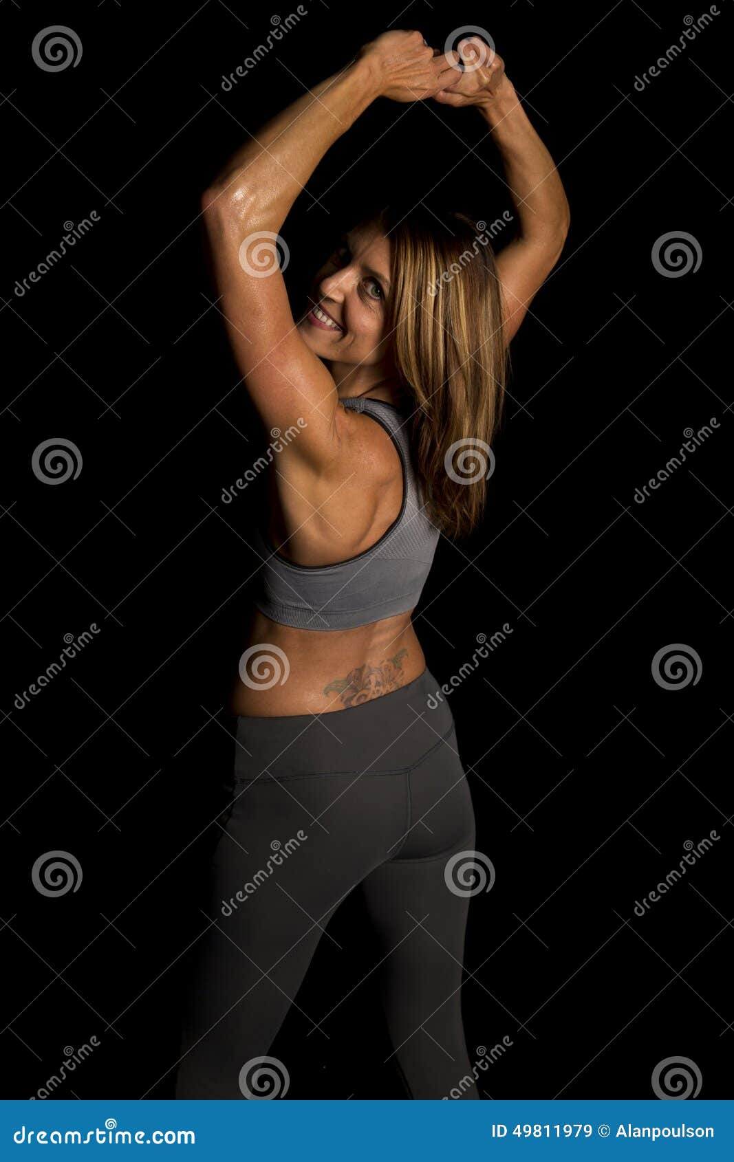 Fit Sporty Young Woman Looking Back Over Shoulder Stock Photos