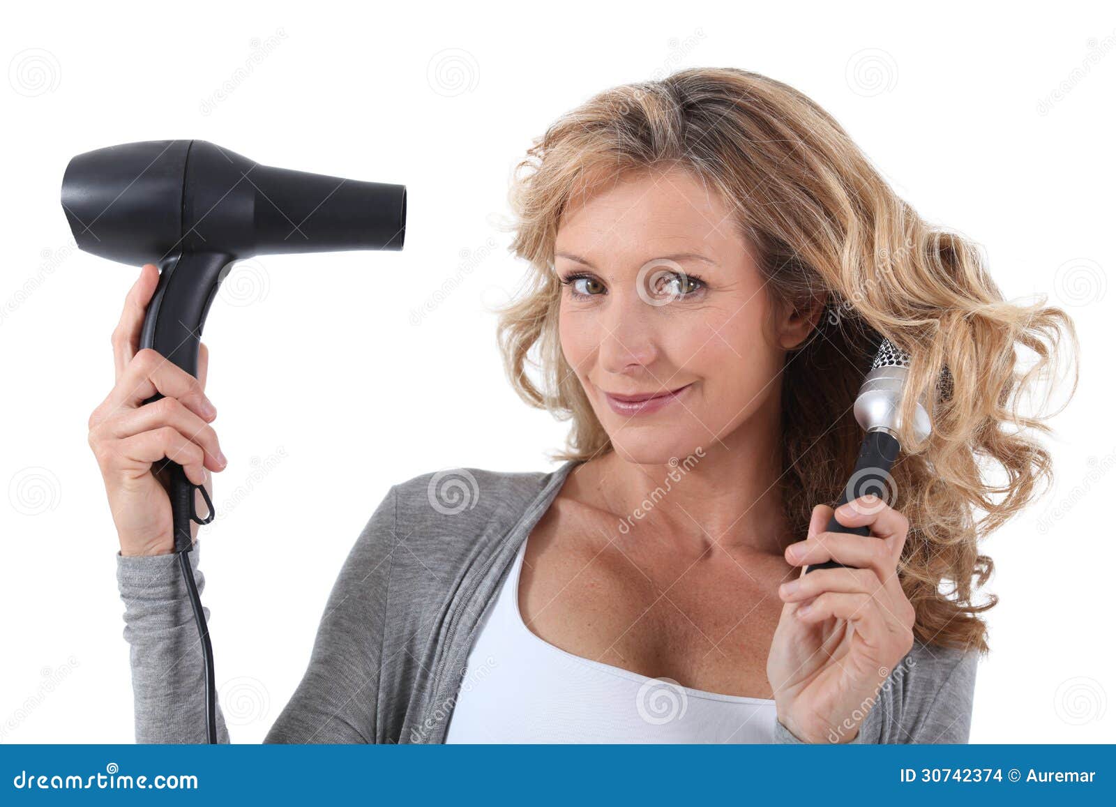 Woman with hair dryer stock photo. Image of smiling, years 30742374