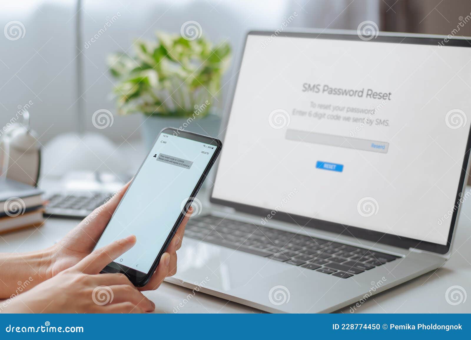 woman hand holding phone showing security code and enters one-time password for the validation process on laptop, mobile otp