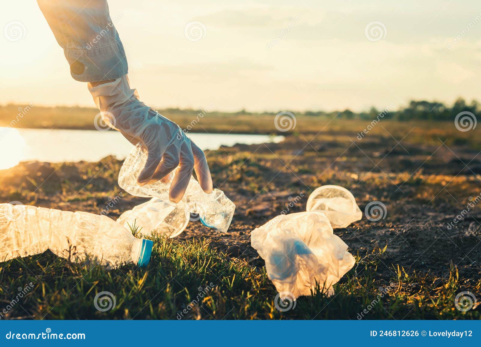 Woman Hand Picking Up Garbage Plastic Bottle for Cleaning at Park Stock