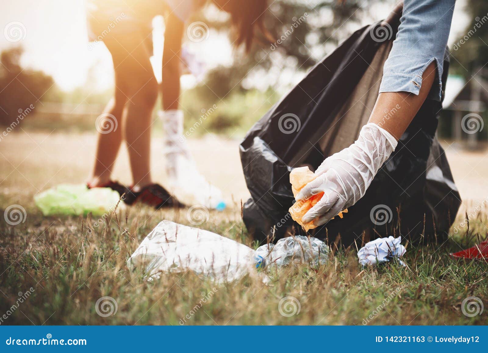 woman hand picking up garbage plastic for cleaning
