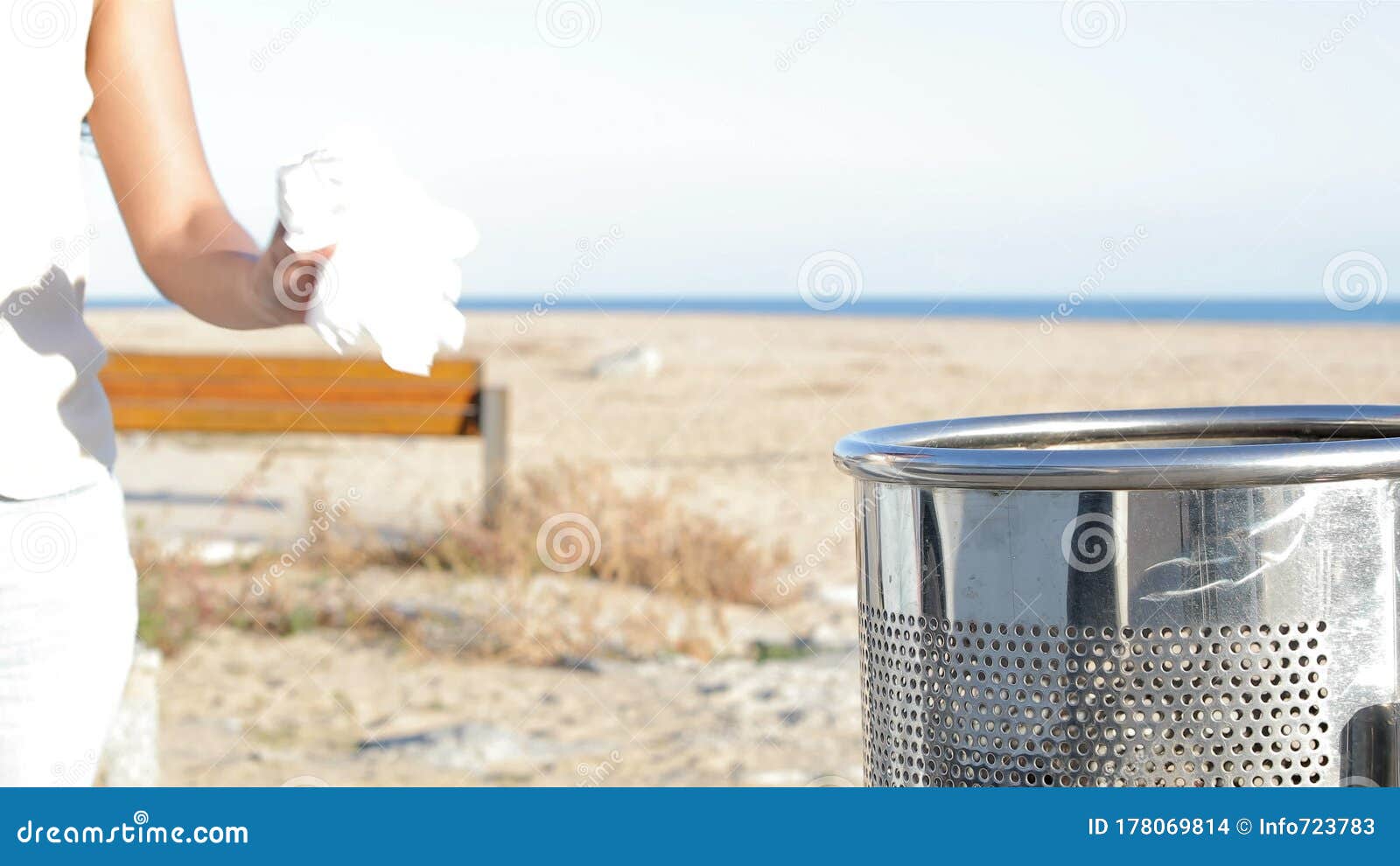 Woman Hand Throwing Trash on the Floor on the Beach Stock Footage