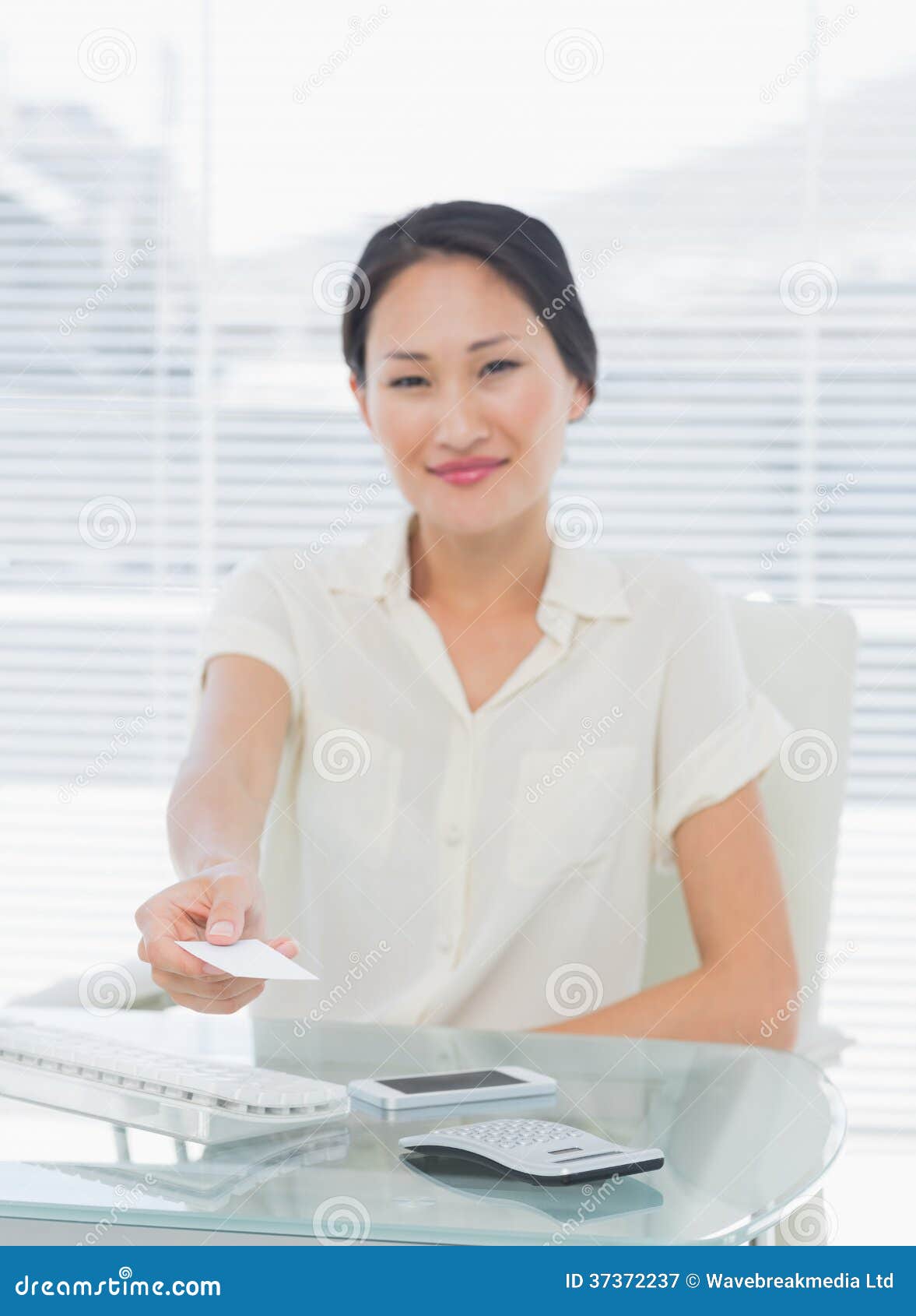 woman-handing-over-her-business-card-desk-37372237.jpg