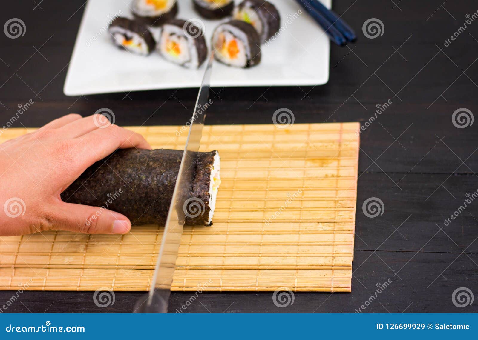 Woman hands cutting sushi stock image. Image of background 126699929