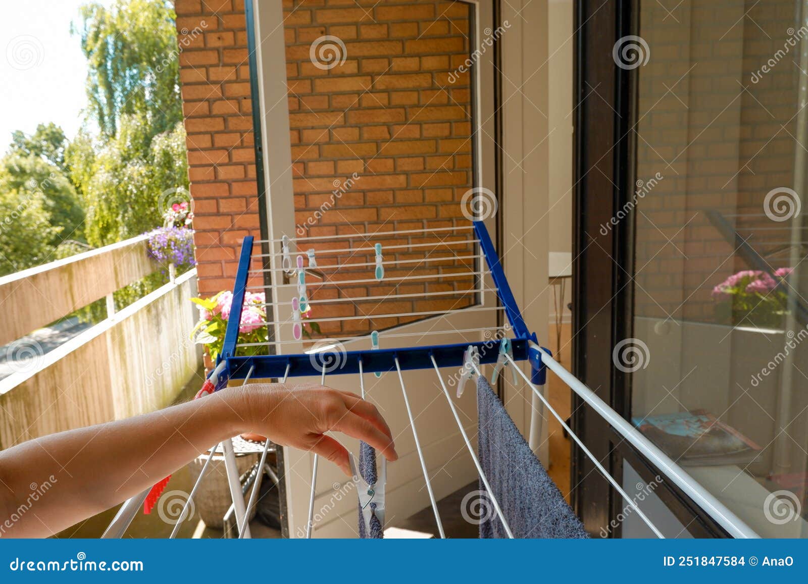 Woman Hands Hanging Her Laundry on Balcony on the Drying Rack. Female  Hanging Clothes on Clothes Line Outdoors Stock Photo - Image of laundry,  holding: 251847584