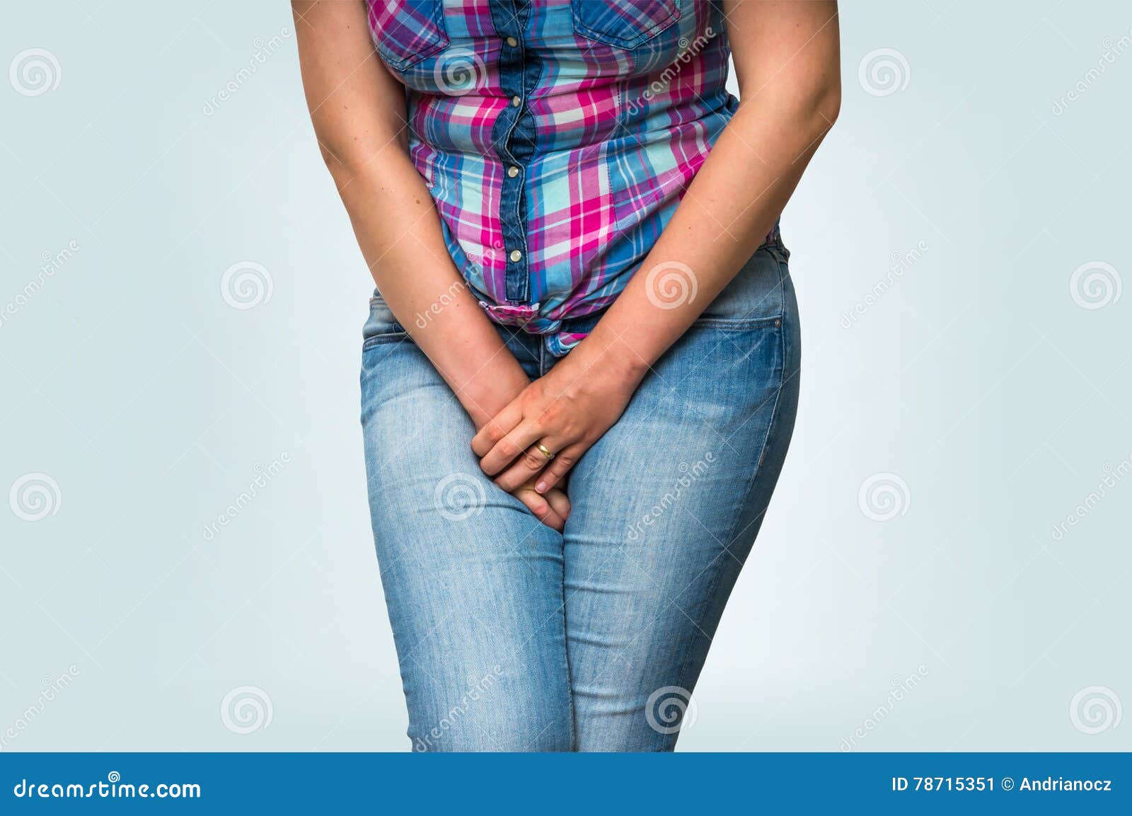 woman covering her crotch with her hands on white background Stock Photo