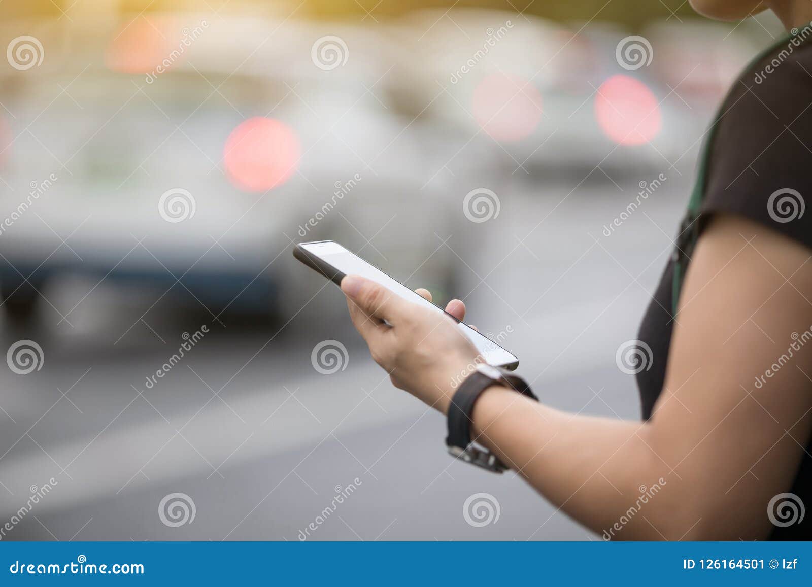 woman hands using smartphone at city