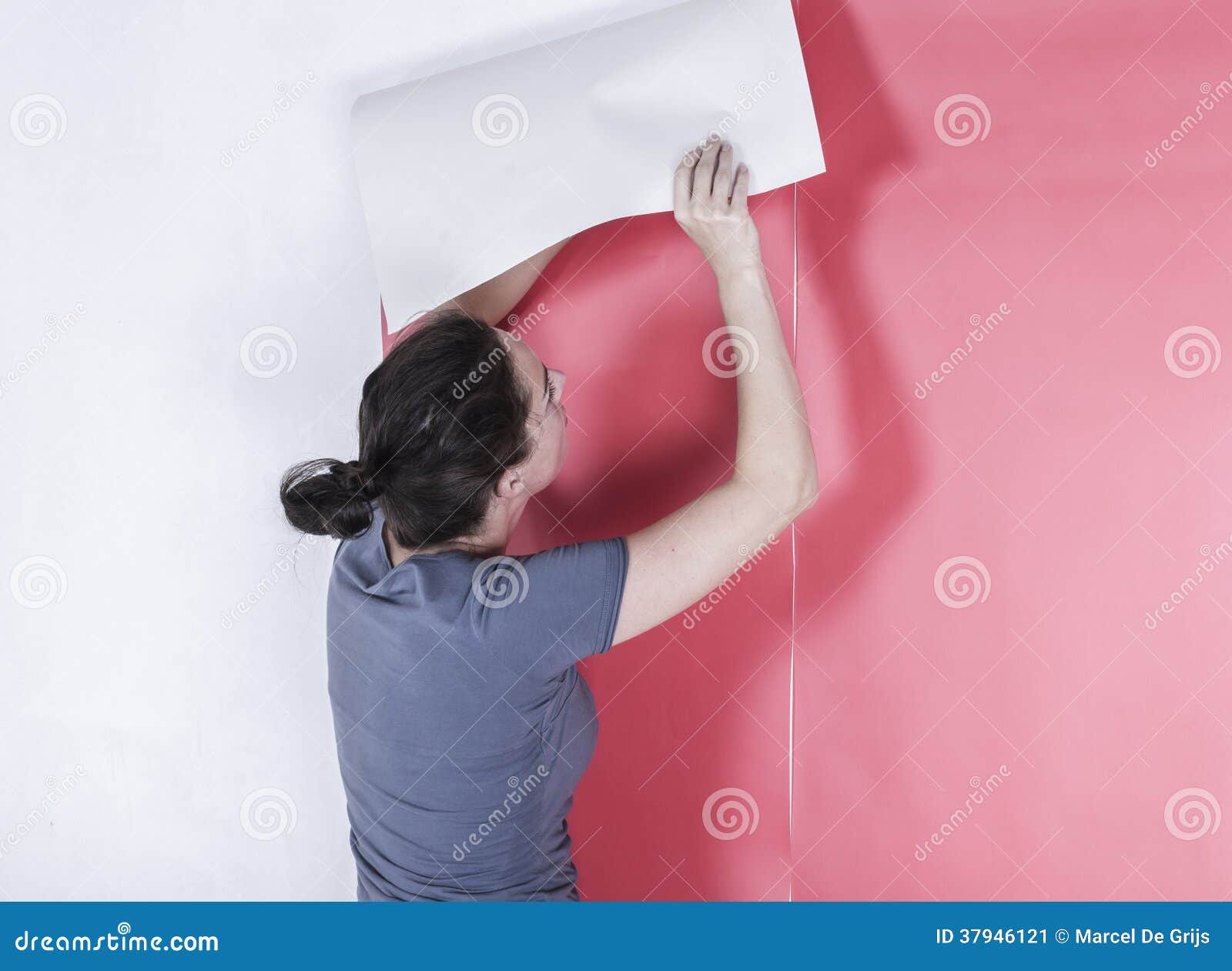 Woman Hanging Wallpaper. Master Woman Glues Wallpaper In The