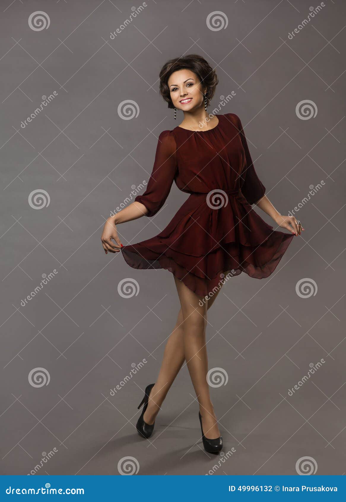 woman happy dancing, smiling glad girl posing in red dress