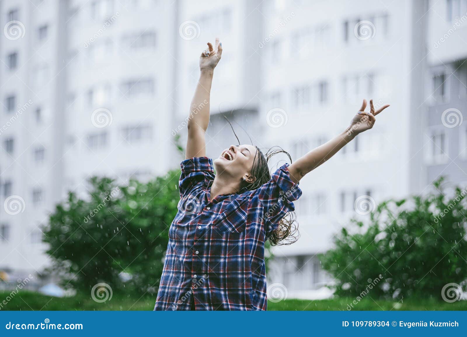 woman happy smiling happiness hands outstretched toward the rain