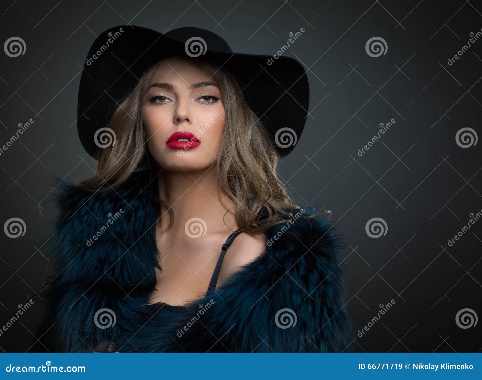 woman in hat on a dark background studo shot