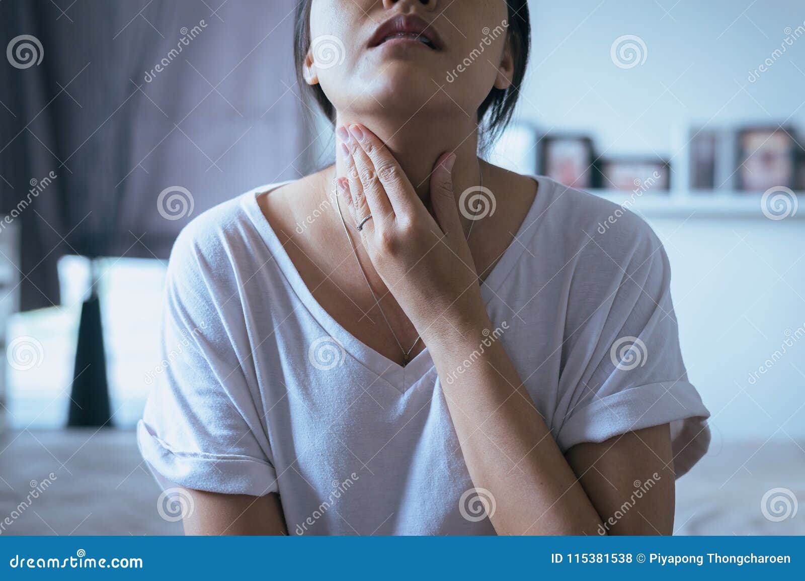 woman have a sore throat,female touching neck with hand,healthcare 