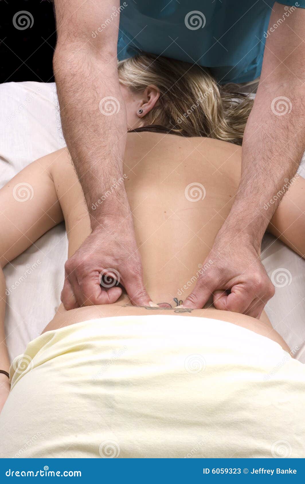 woman having back massage from masseur