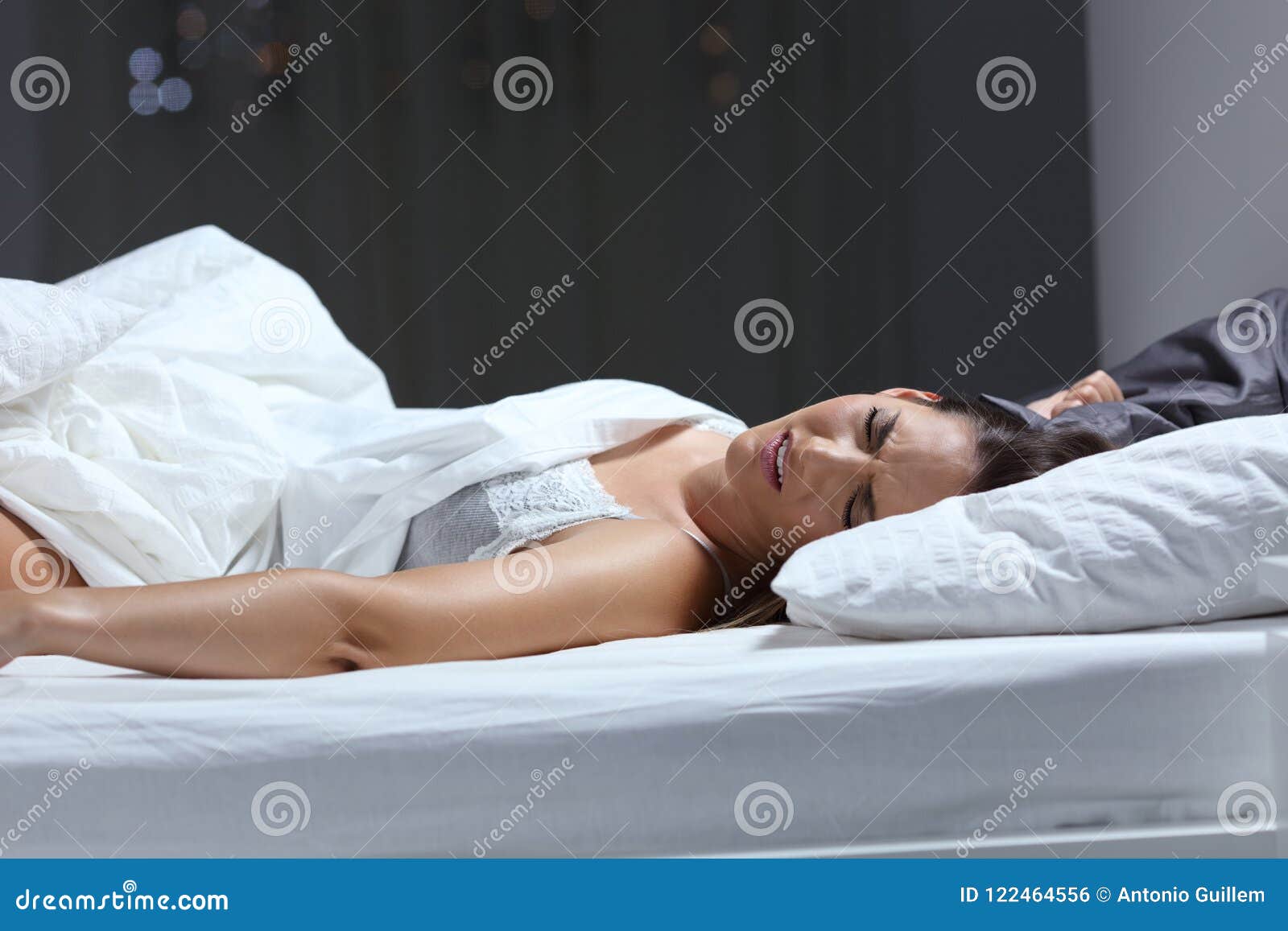 woman having a nightmare in the bed in the night