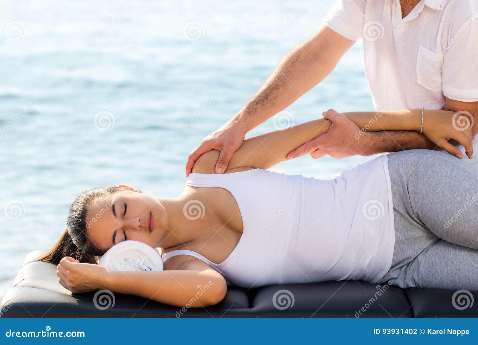 woman having osteopathic treatment at sea side.