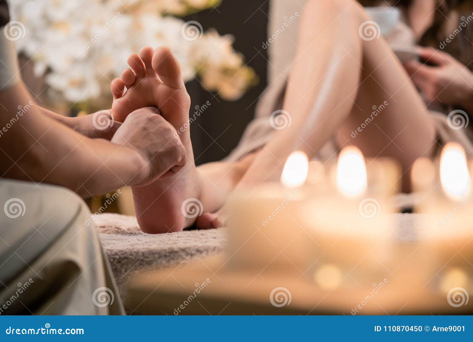 woman having reflexology foot massage in wellness spa