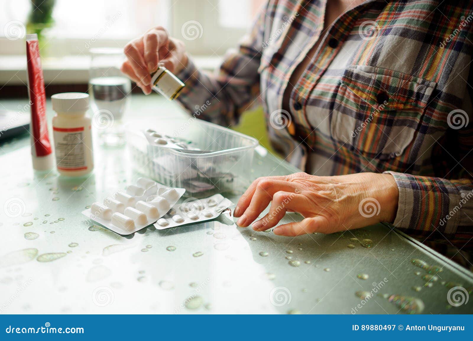 the woman having rheumatoid arthritis takes medicine.