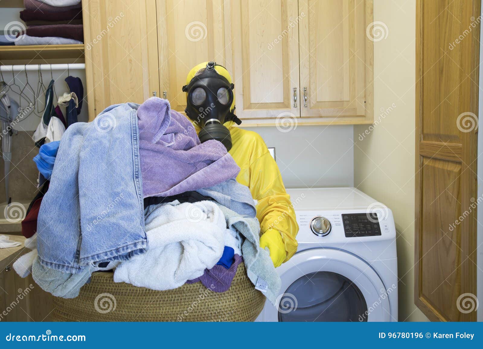 woman in haz mat suit holding basket of laundry