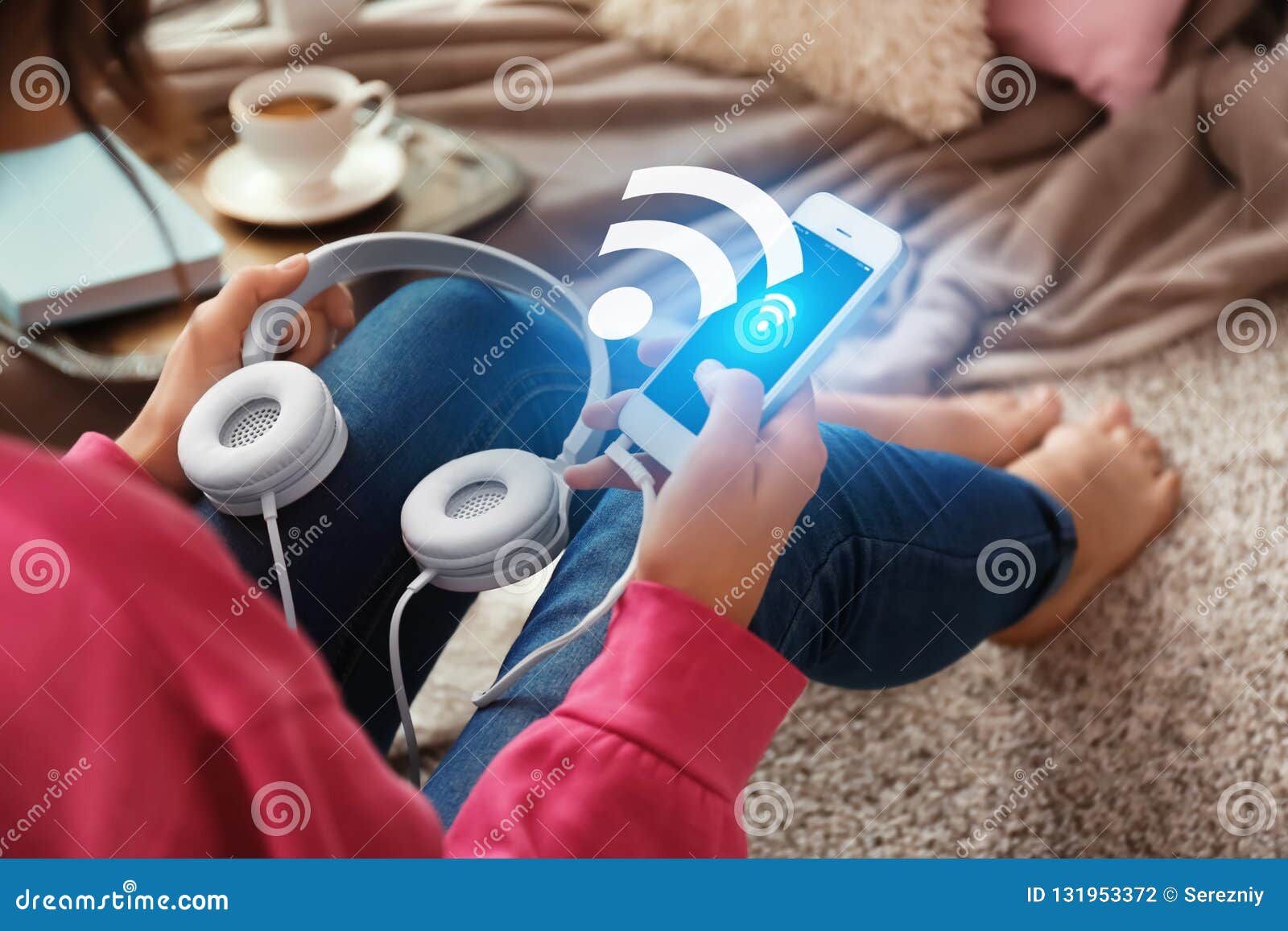 woman with headphones and smartphone using free wi-fi at home