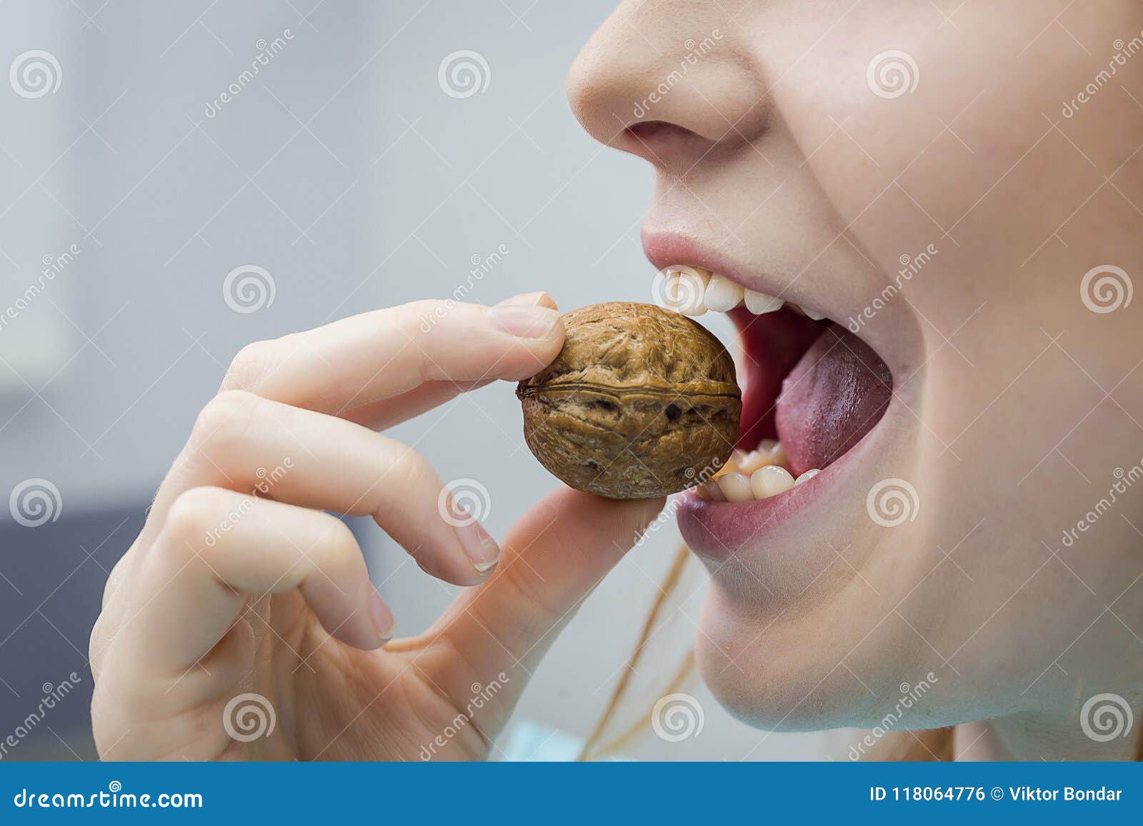 Woman with Healthy Tooth Cracking Walnut Stock Photo Image of hand, food 118064776