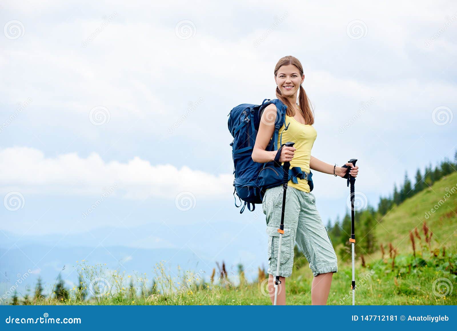 Woman Hiker Hiking On Grassy Hill, Wearing Backpack, Using 