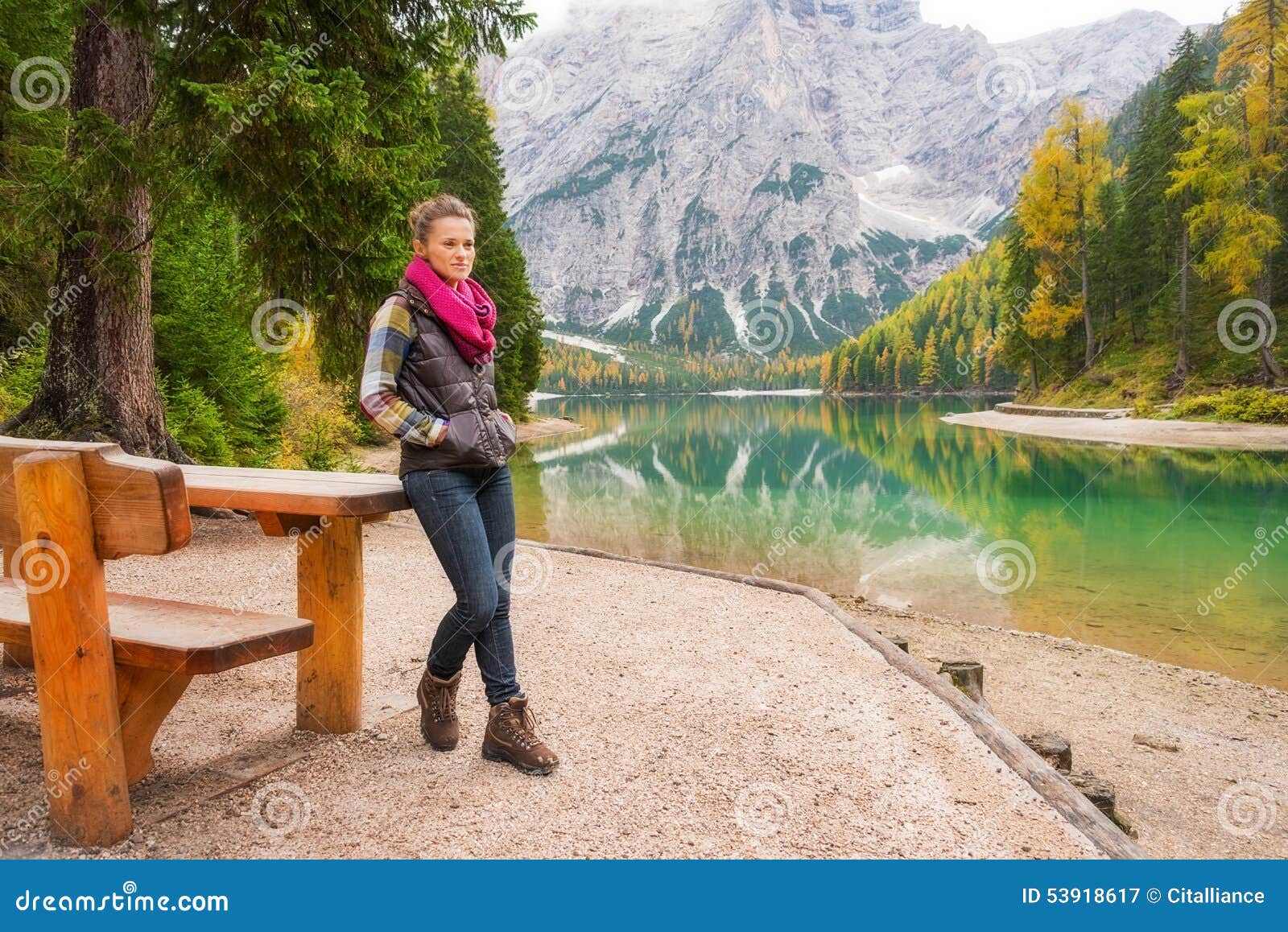 woman hiker resting at picnic table on lake bries