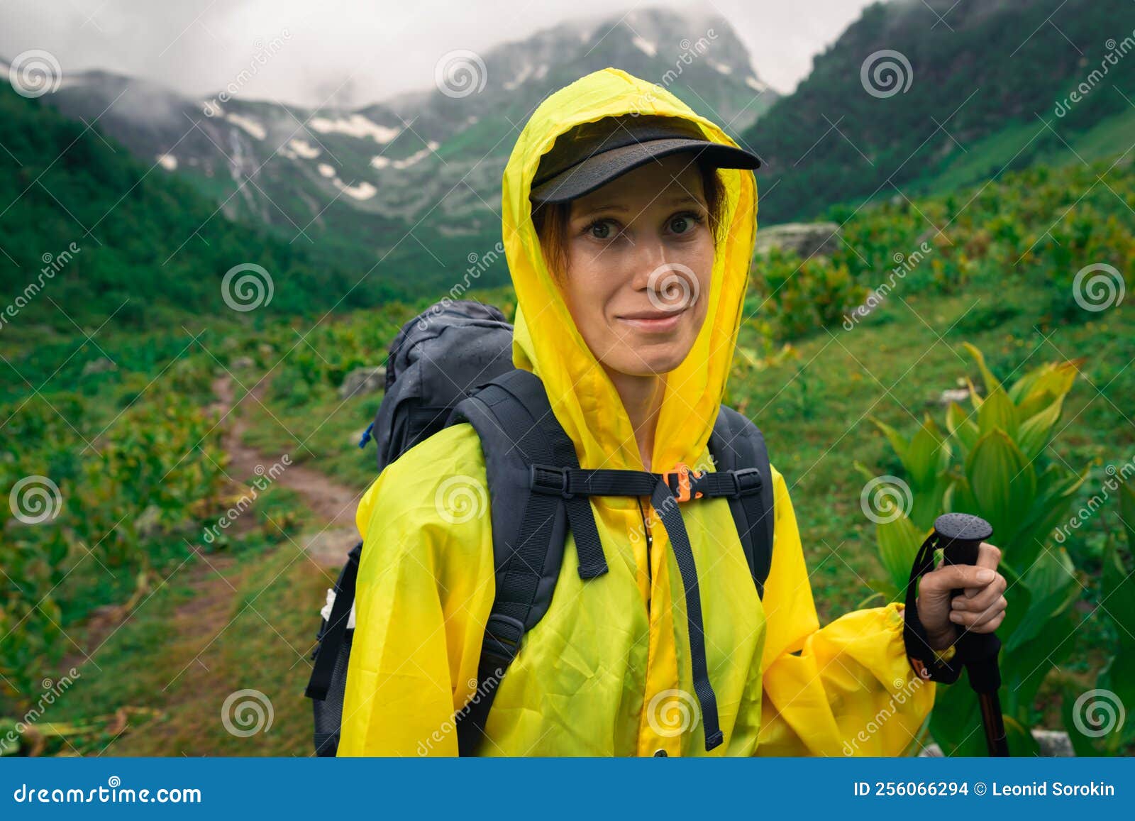 Woman Hiker in Yellow Raincoat Hiking in Valey in Mountain Stock Photo ...