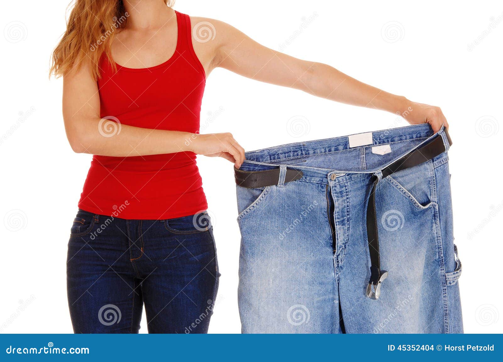 Woman holding big pants. stock photo. Image of figure - 45352404