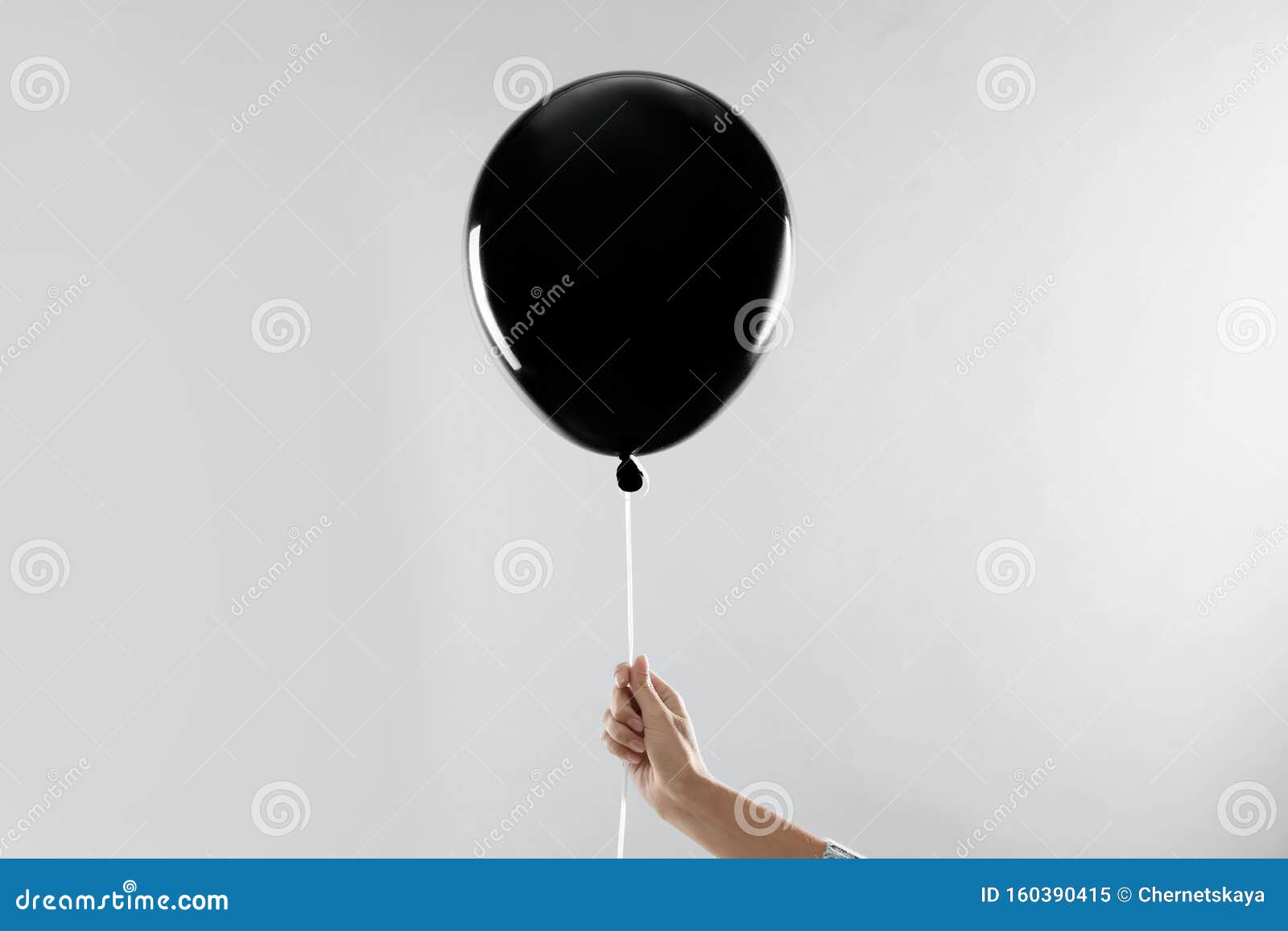 Woman Holding Black Balloon For Halloween Party On Light Grey