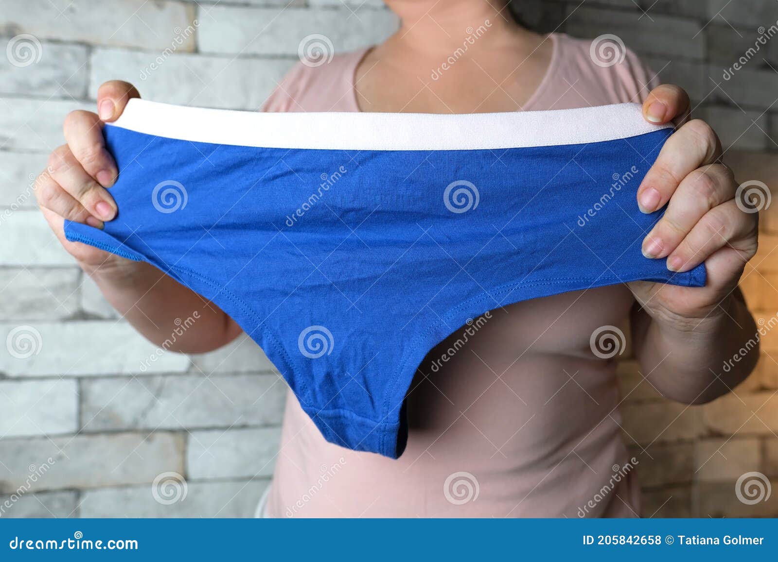 Woman Holding Blue Female Panties in Her Hands, Knitted Underwear