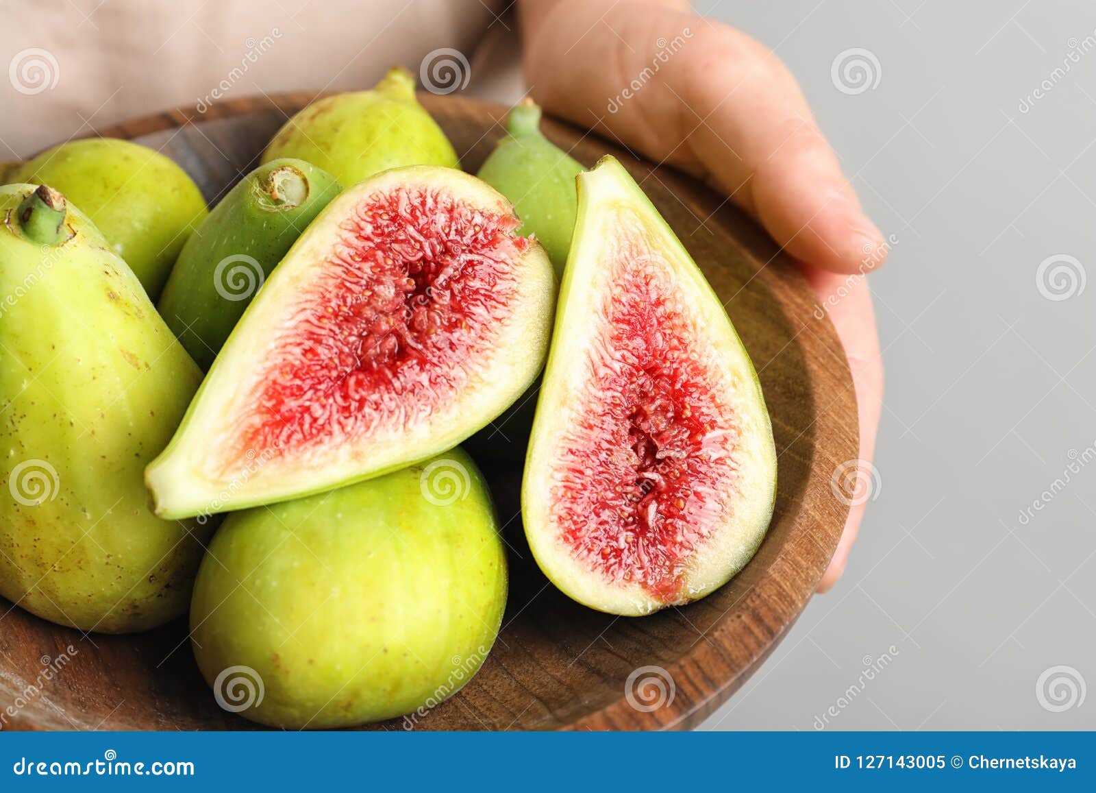 Women hand holding figs on kitchen table with baking tools at window  background. Lifestyle - a Royalty Free Stock Photo from Photocase