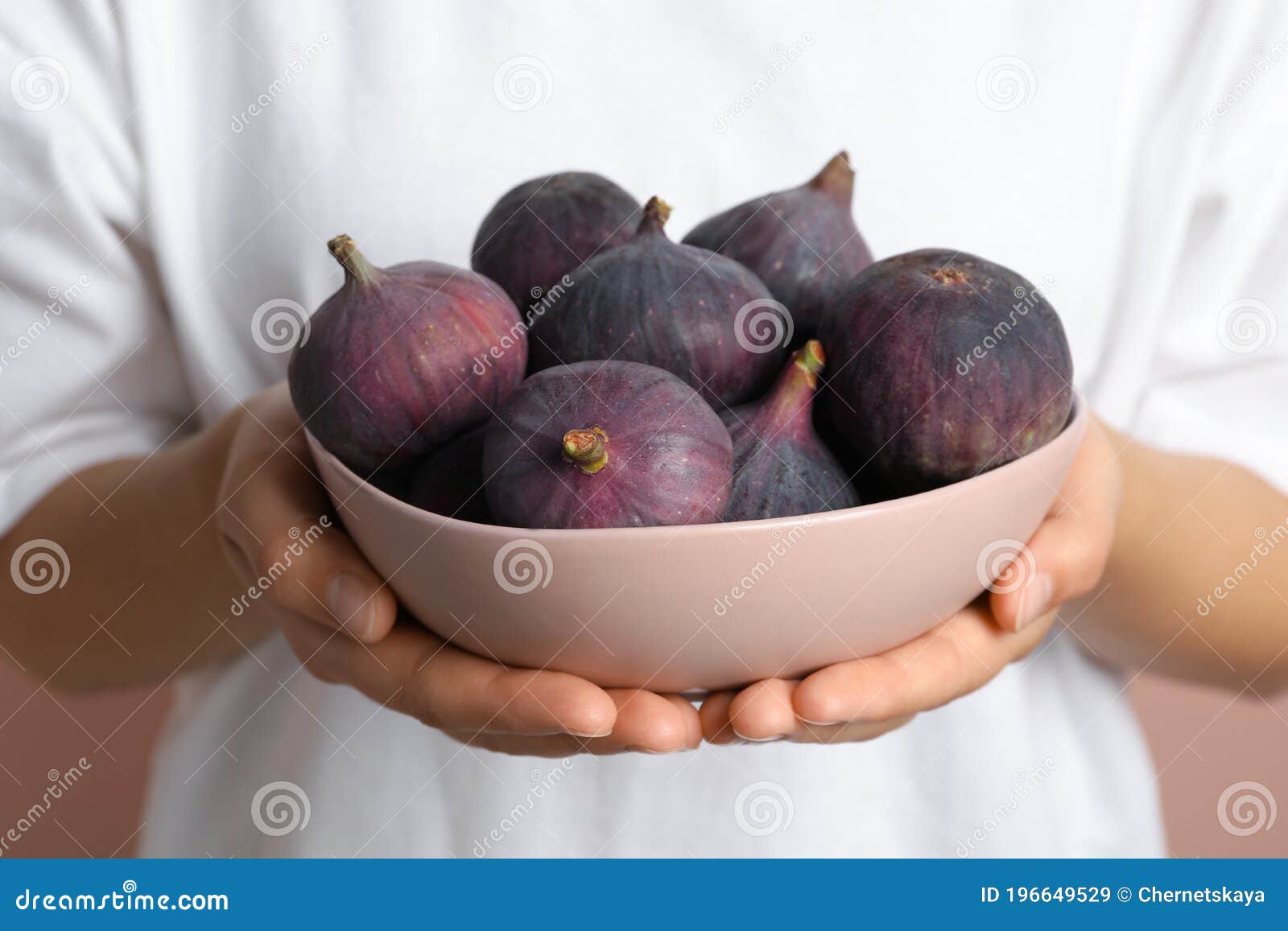 Women hand holding figs on kitchen table with baking tools at window  background. Lifestyle - a Royalty Free Stock Photo from Photocase