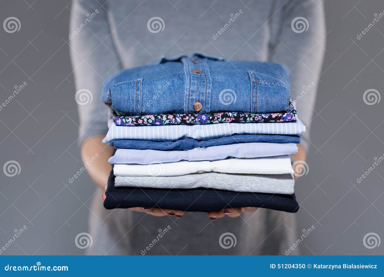 woman holding clothes in hands