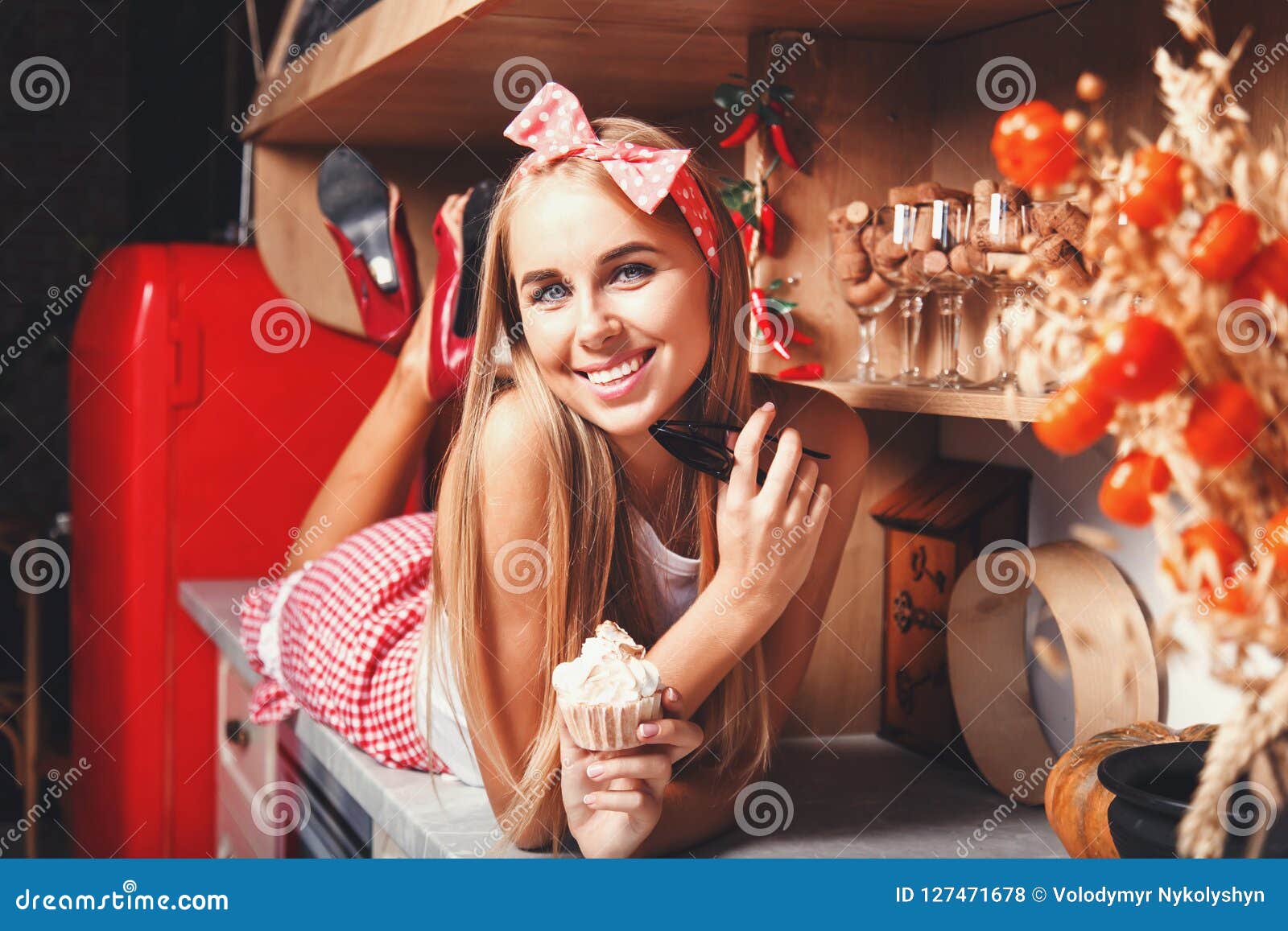 woman holding cupcake and sunglasses