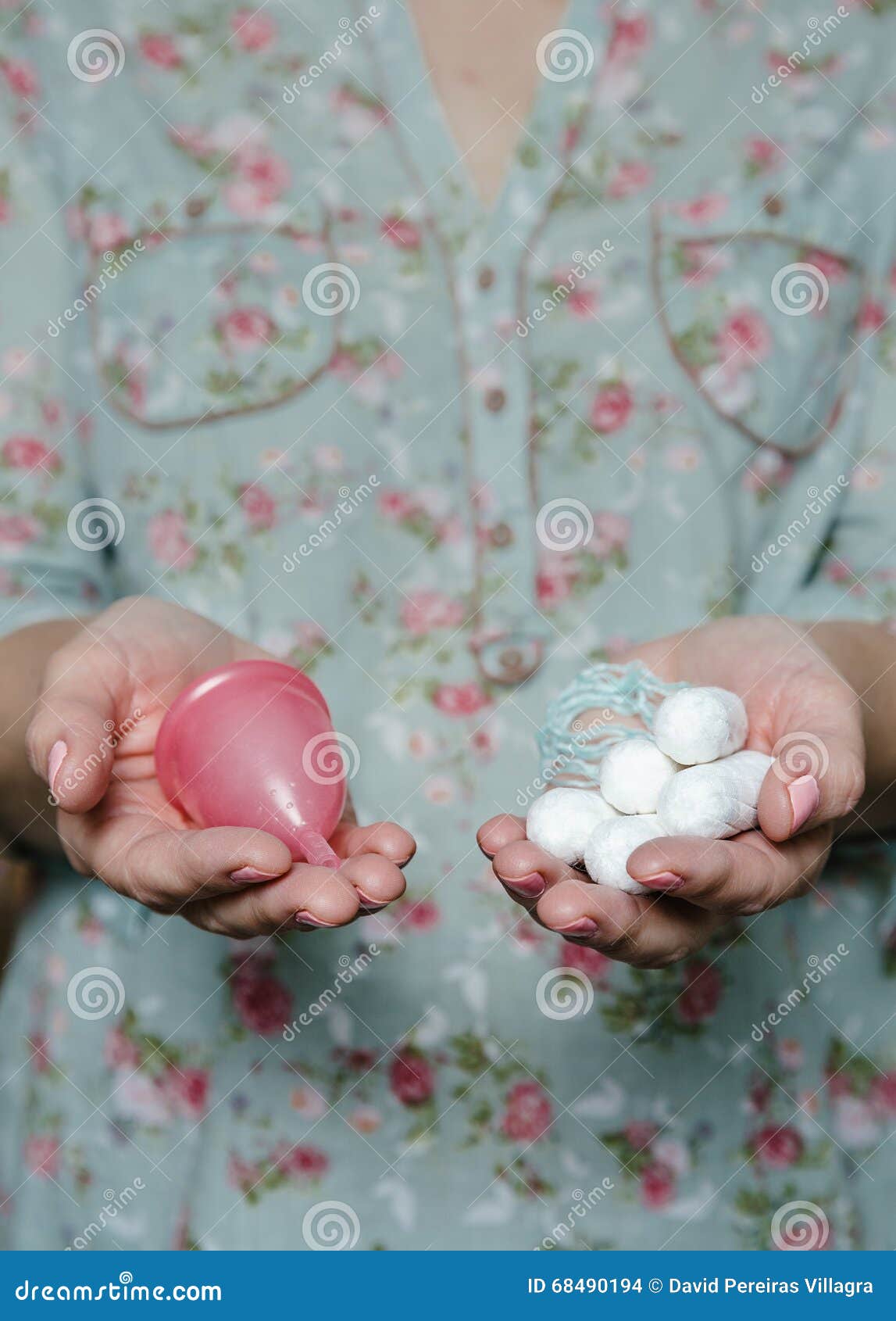 woman holding in hands tampons and menstrual cup