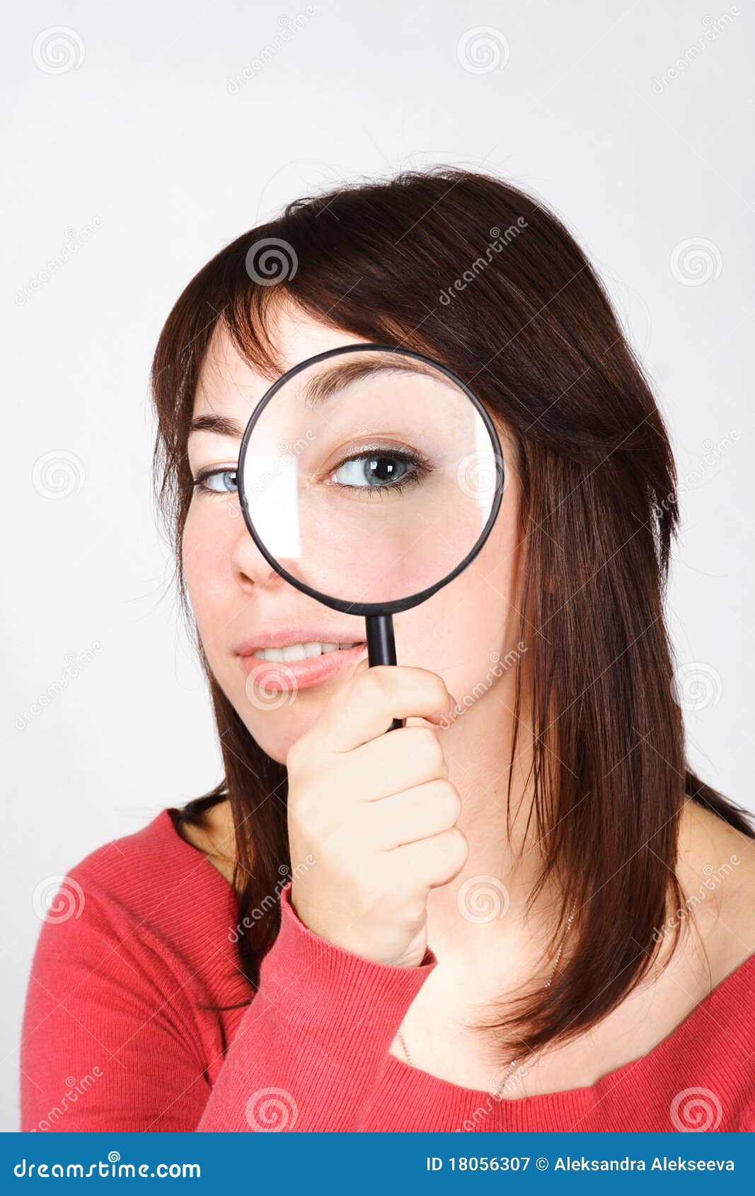 woman holding magnifier and looking through it
