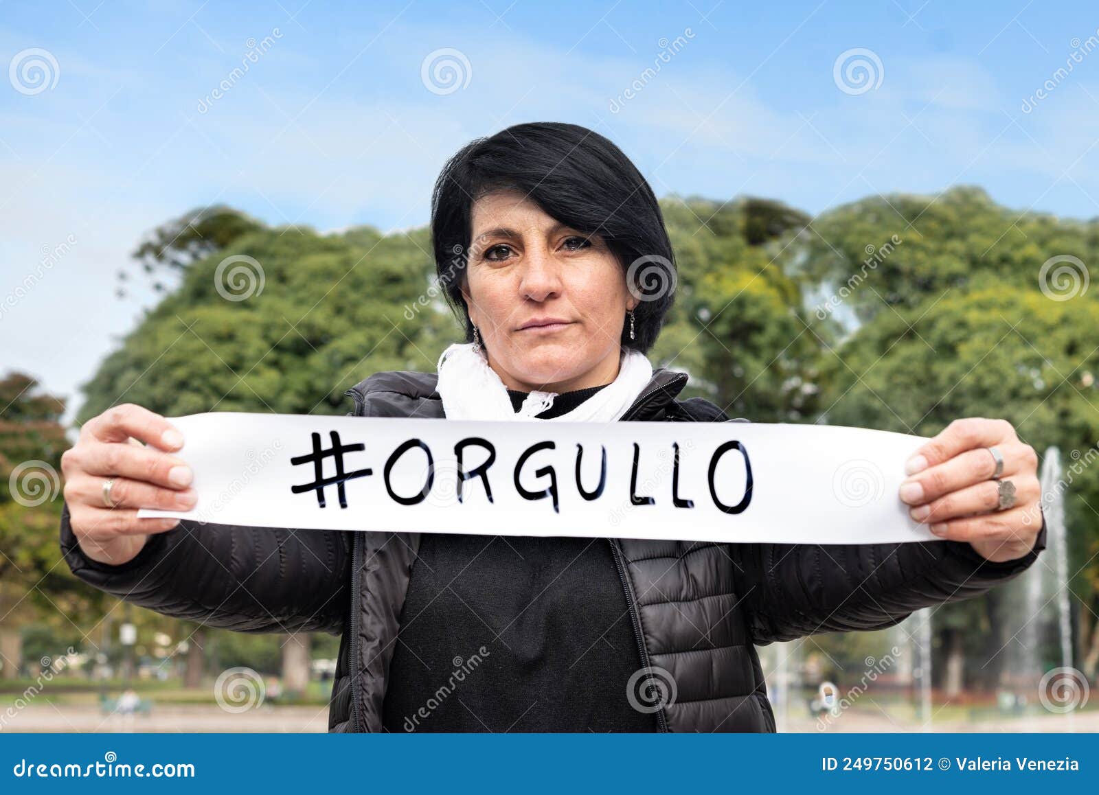 woman holding an  orgullo or  pride sign.