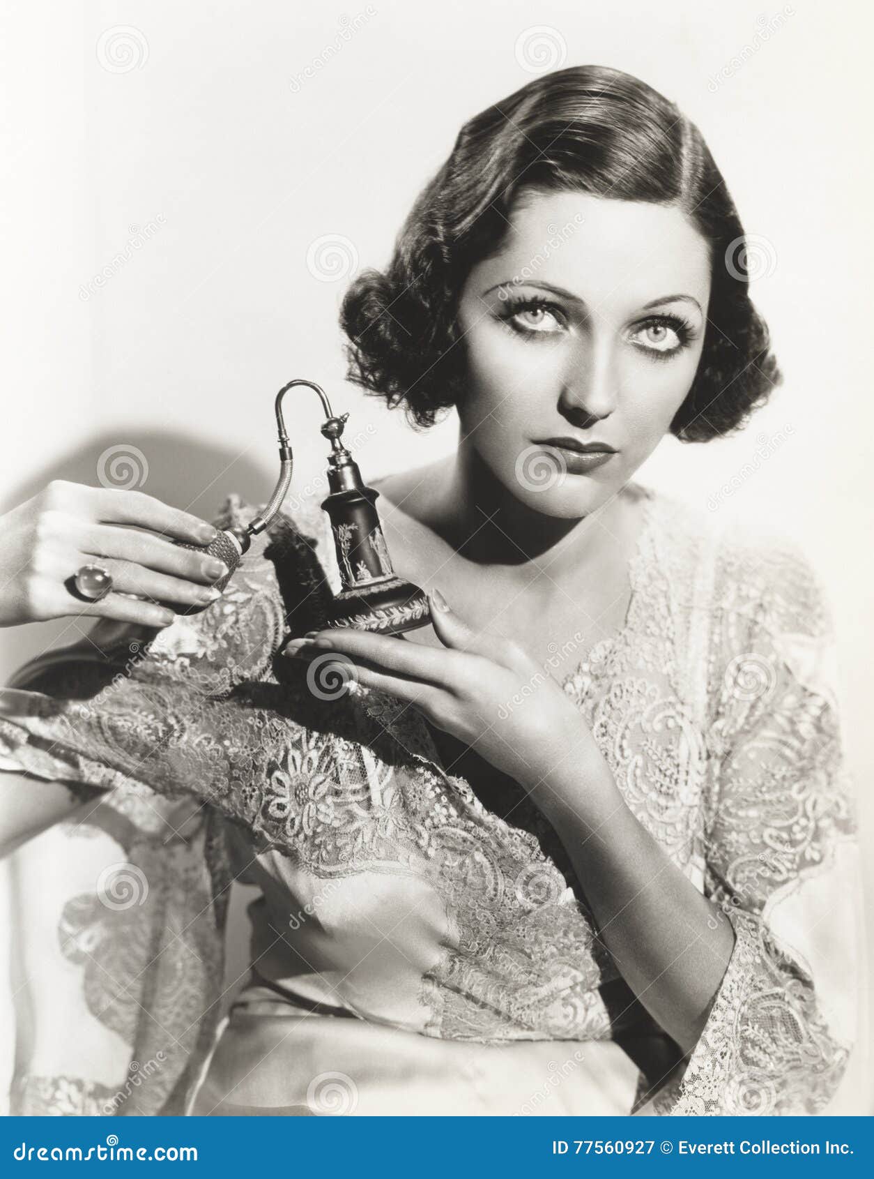 woman holding perfume atomizer
